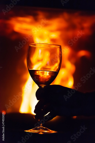 glass of wine beside the fire