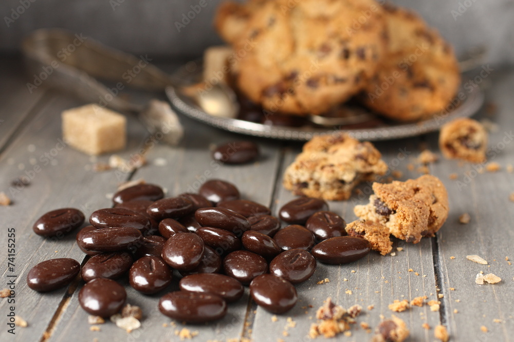 Chocolate candy with chocolate chip cookies on wooden background Chocolate candy with chocolate chip cookies on wooden background