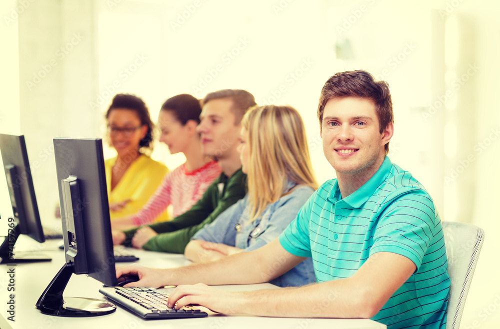 male student with classmates in computer class male student with classmates in computer class
