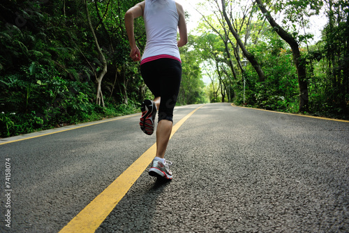 fitness woman running at forest road