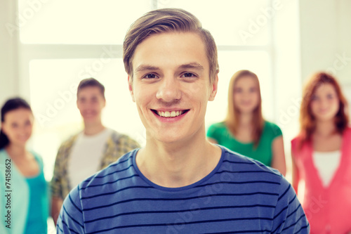 smiling students with teenage boy in front