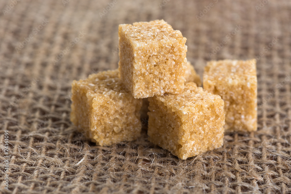 cubes of brown sugar on jute bags cubes of brown sugar on jute bags
