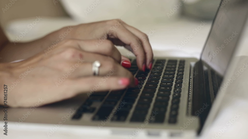 Fingers typing text on the MacBook's keyboard. Fingers typing text on the MacBook's keyboard.