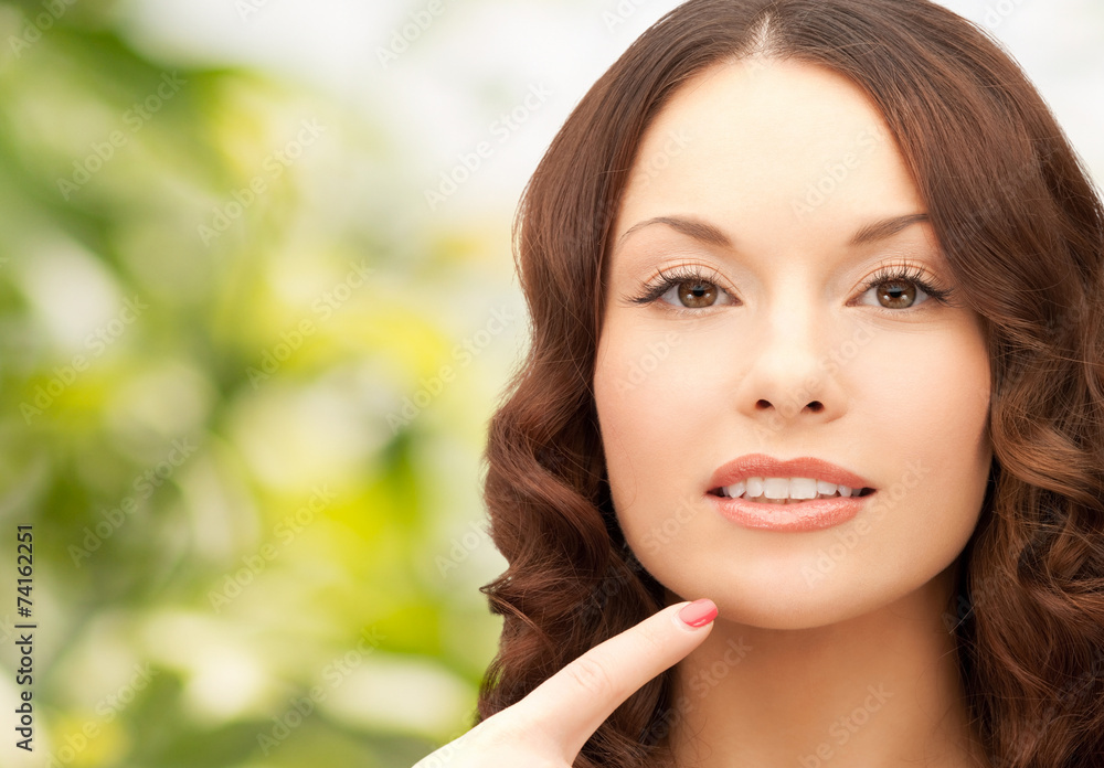 beautiful young woman pointing finger to her chin beautiful young woman pointing finger to her chin