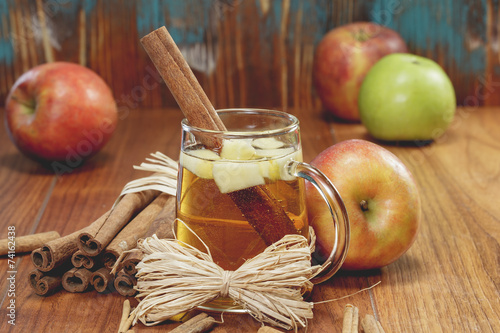 Apple cider and apples on rustic wood.   Winter drink