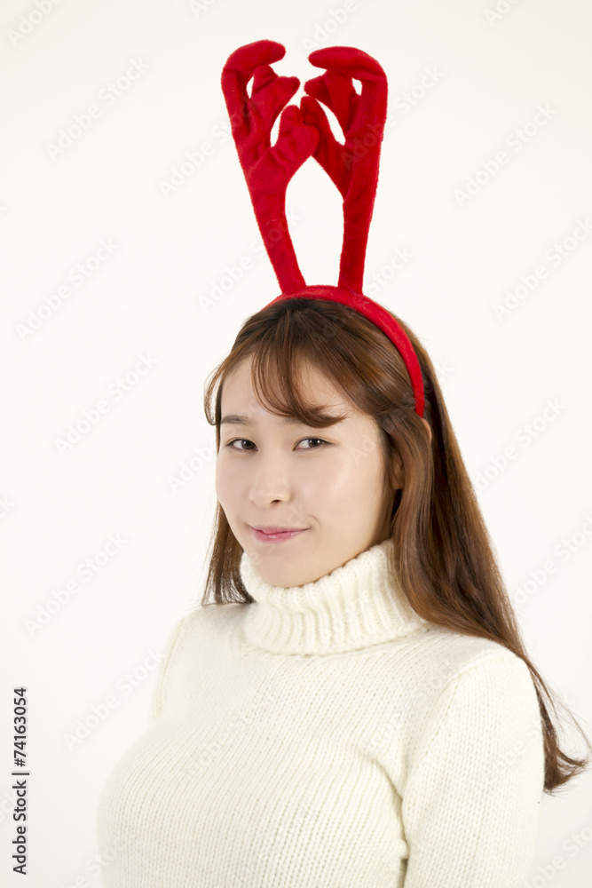 Young beautiful asian woman wearing Christmas antlers Young beautiful asian woman wearing Christmas antlers