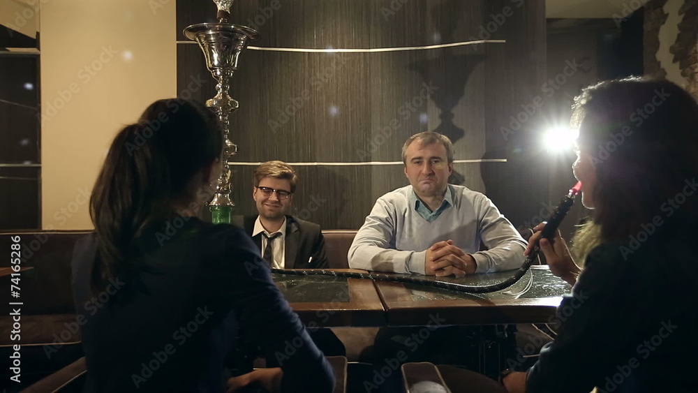 Company people enjoy hookah and communication. Company people enjoy hookah and communication.
