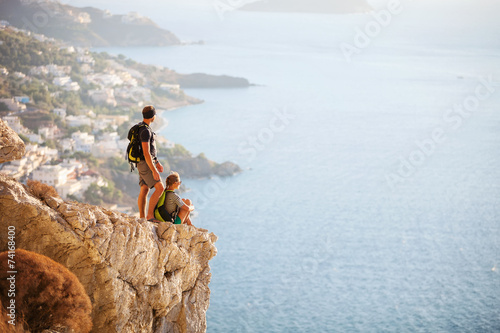 Young couple resting on edge of rock