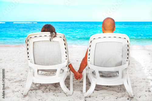 Couple relaxing on sunbed