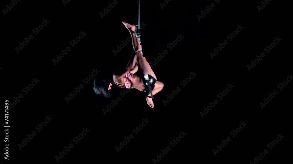 Young woman air gymnast on black background Young woman air gymnast on black background