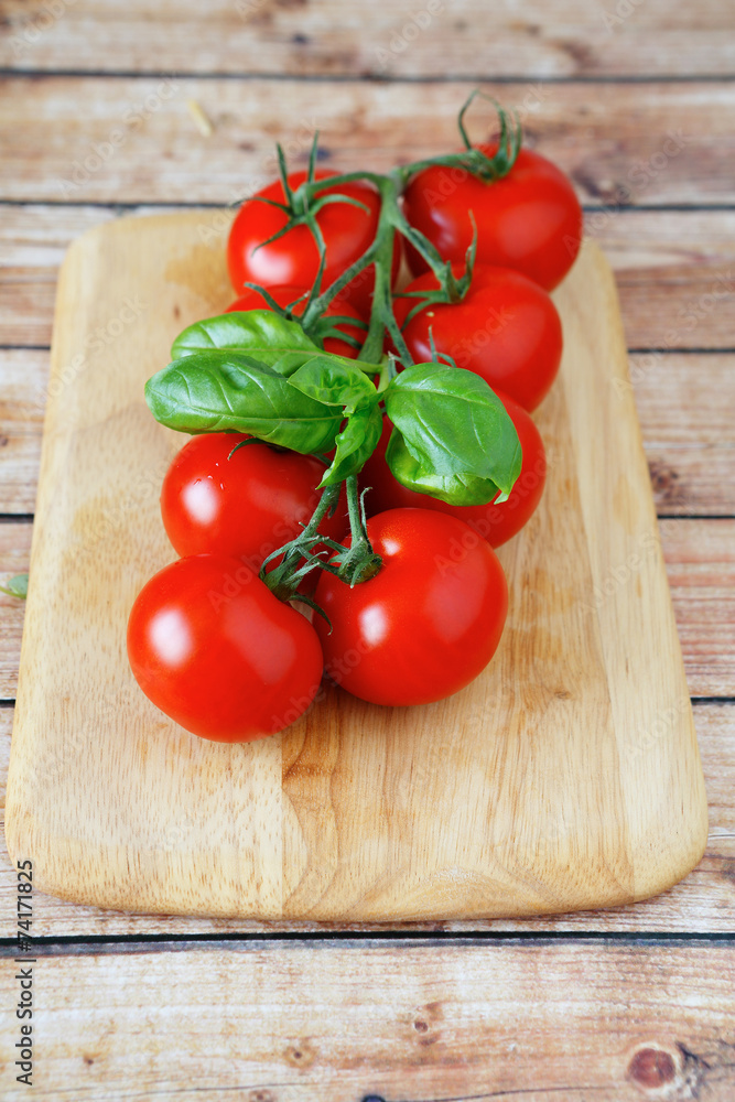 branch of red tomatoes on the board branch of red tomatoes on the board