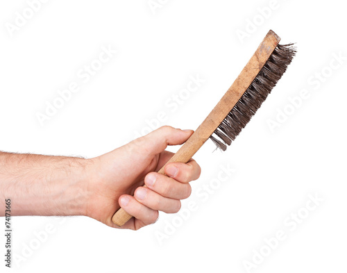 Isolated steel brush in male hand
