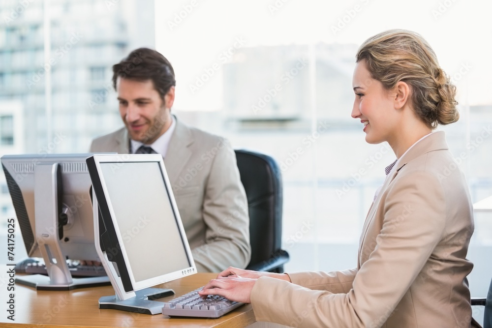 Smiling business people using computer Smiling business people using computer