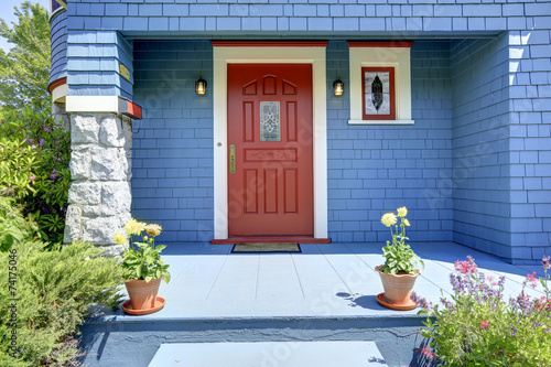 Blue entrance porch with red door.
