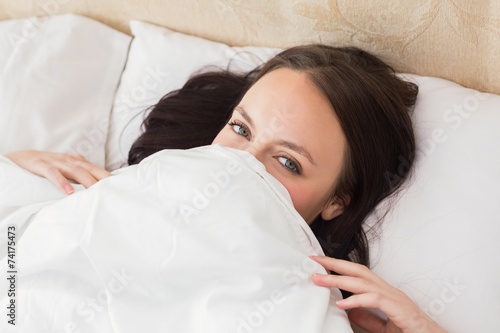 Pretty brunette under the duvet