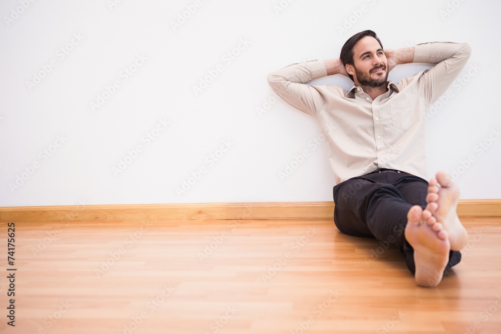 Thoughtful man leaning against wall with crossed arms Thoughtful man leaning against wall with crossed arms