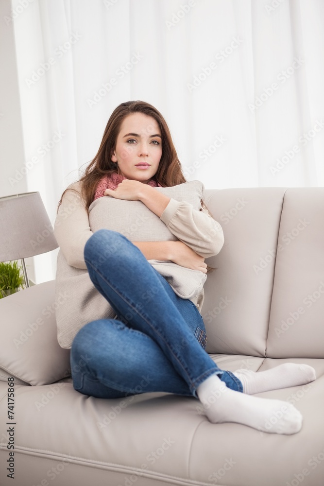 Pretty brunette hugging a cushion Pretty brunette hugging a cushion