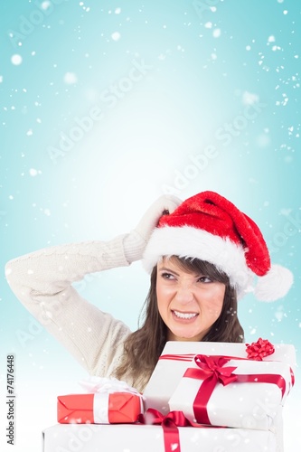 Cute brunette scratching head and holding gifts