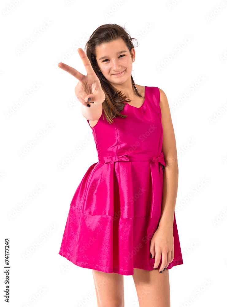 Girl doing victory gesture over white background Girl doing victory gesture over white background