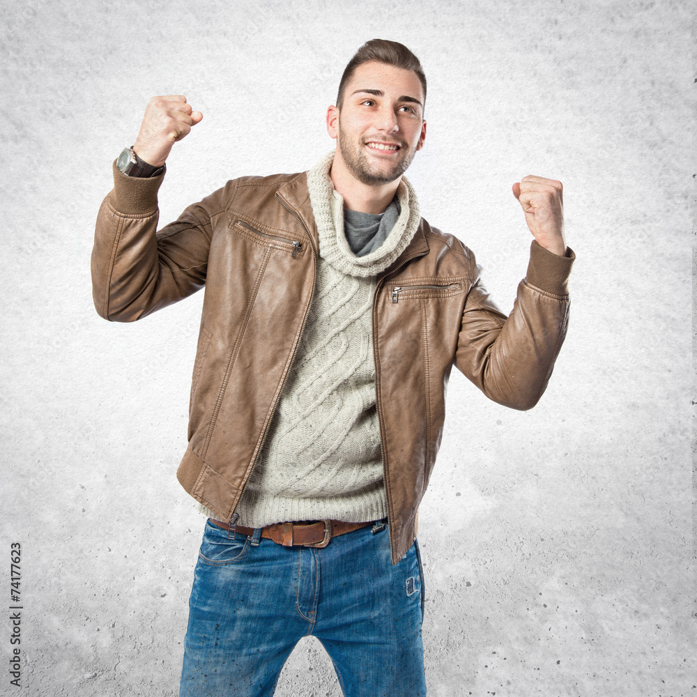 Fototapeta premium Young man winner over isolated white background