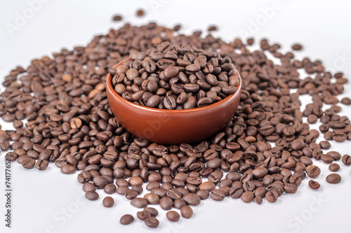 brown bowl with coffee beans on a heap