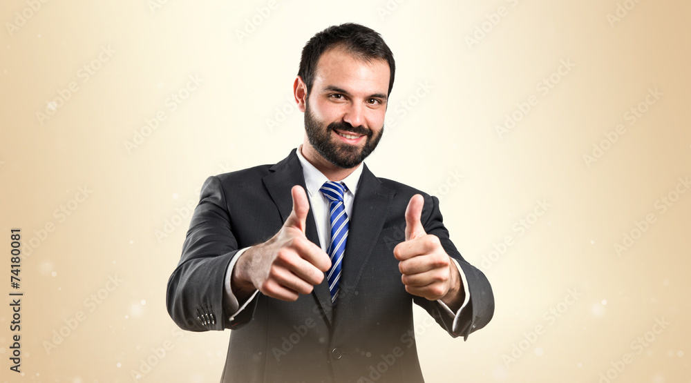 Young businessman getting OK over white background Young businessman getting OK over white background