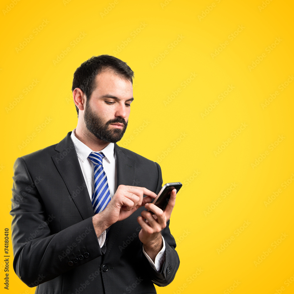 Business man sending a message over yellow background. Business man sending a message over yellow background.