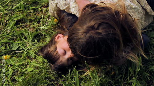 European, white-skinned children fight on green grass.