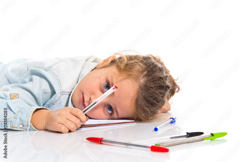 Blonde little girl studing on the floor Blonde little girl studing on the floor