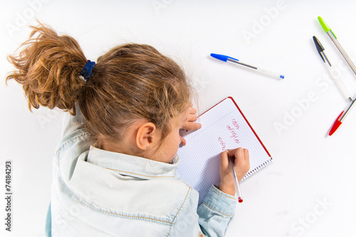 Blonde little girl writing