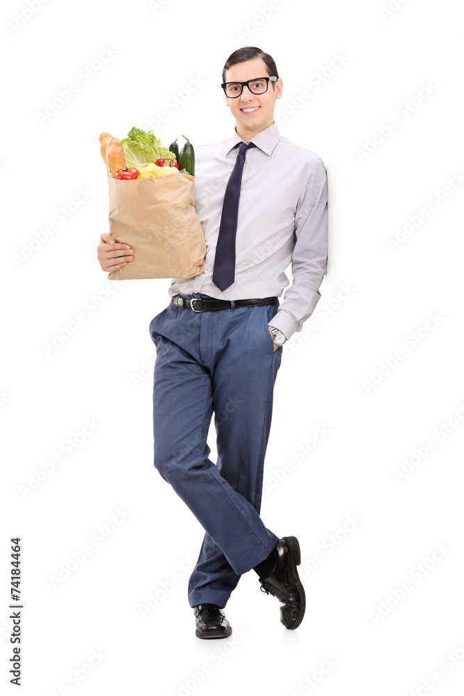 Elegant man holding a grocery bag