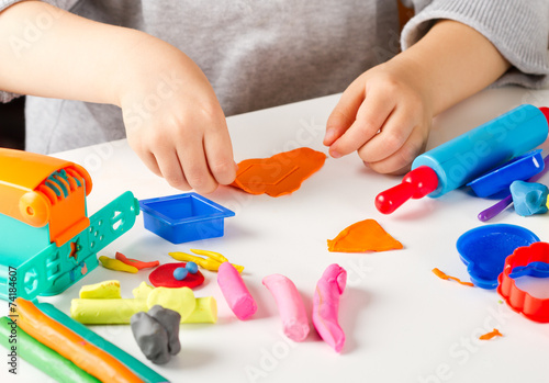 Child hands  with colorful clay