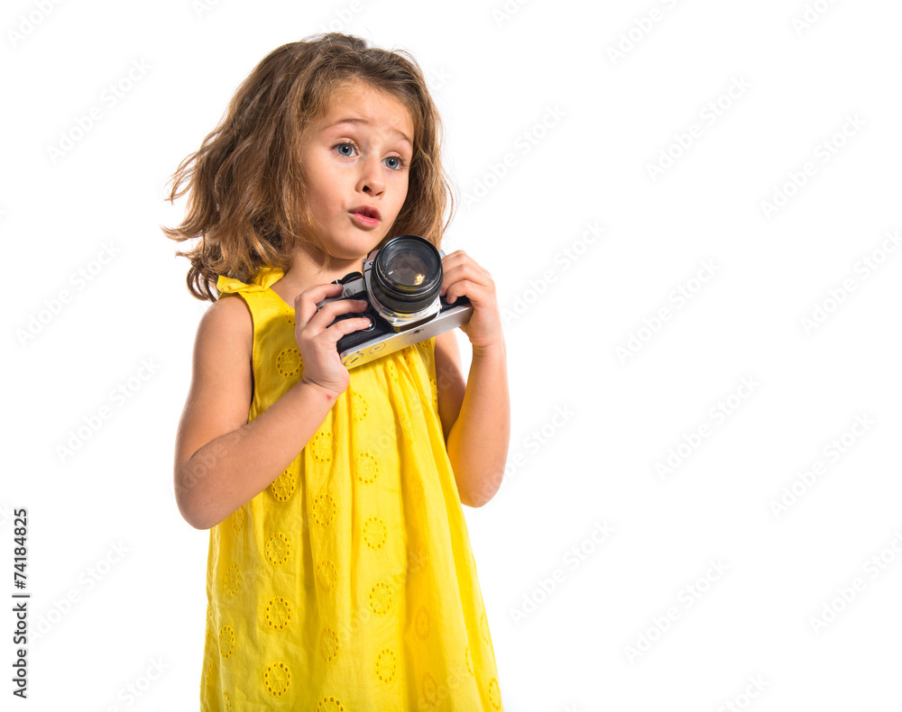 Obraz premium Blonde little girl photographing something