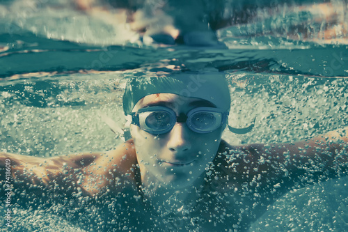 Young boy swimming underwat...