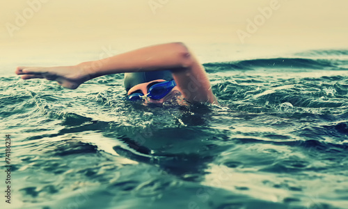 Close up of young boy swimming in sea © Orlando Florin Rosu