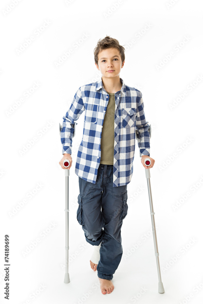 Teenage Boy with crutches and a bandage on his right leg Teenage Boy with crutches and a bandage on his right leg