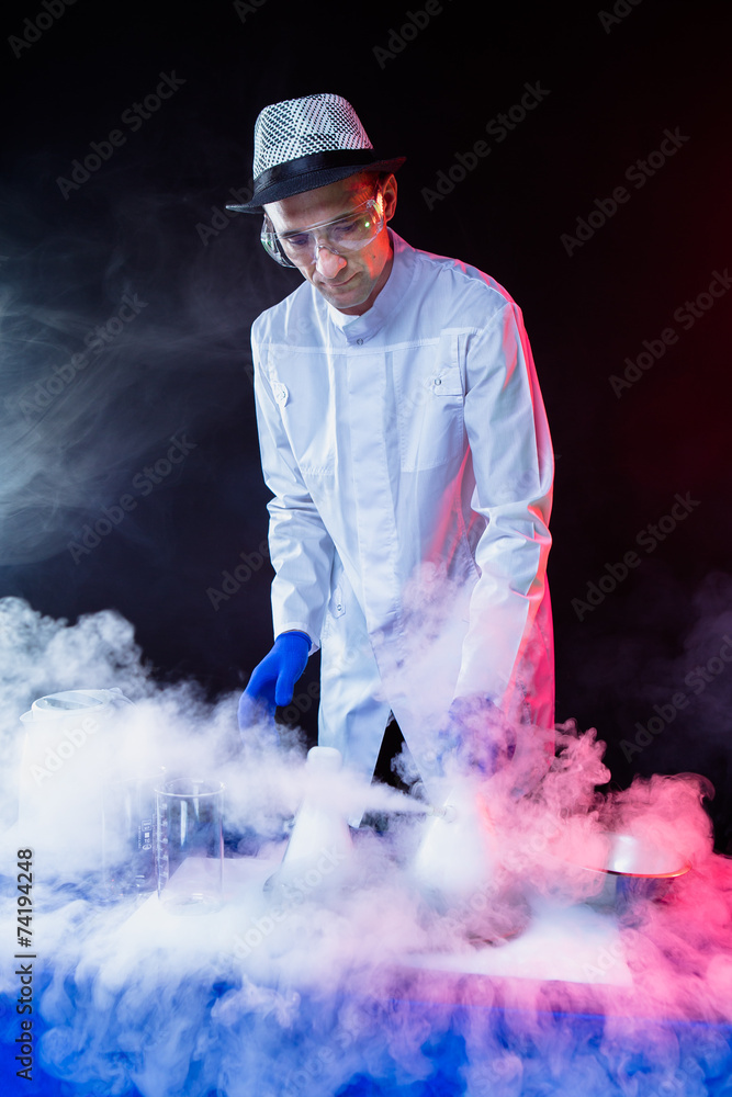 Smiling man scientist with dry ice