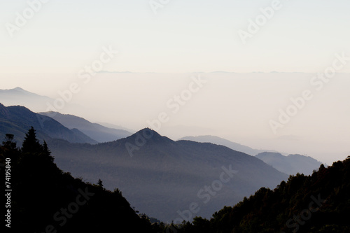layers of mountains and fog at sunrise