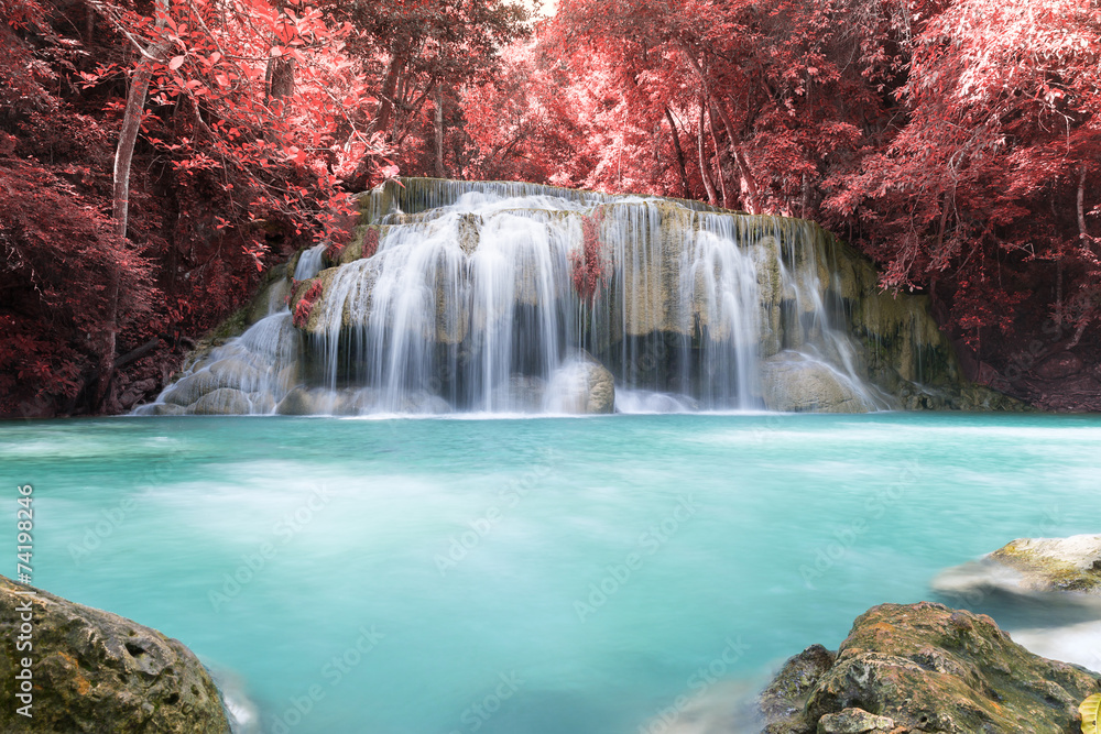 Waterfall, green forest in Erawan National Park, Thailand. Landscape with water flow, river, stream and rock at outdoor. Beautiful scenery of nature for tourist to tour, visit, relax in vacation.