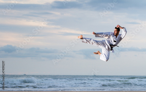 Man jumping to practice Marcial Arts kick