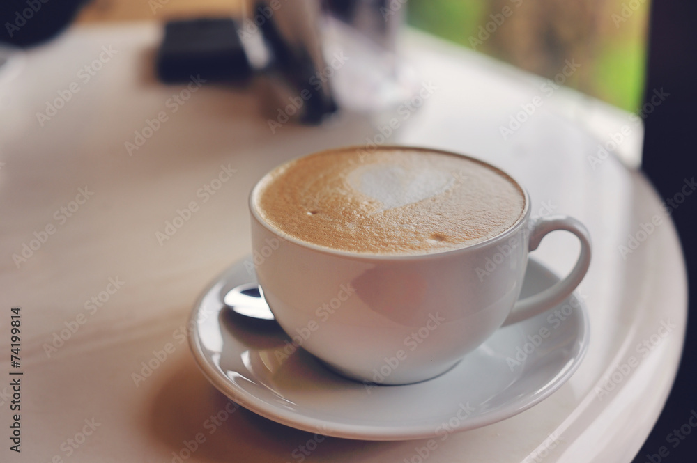 Cup of coffee with heart pattern