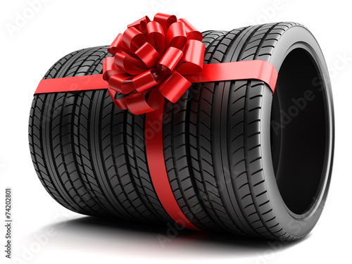 Gift set of tires wrapped ribbon and bow isolated photo