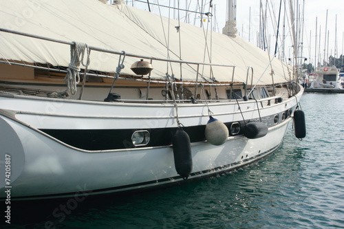 sailing yacht with canvas cover in marina