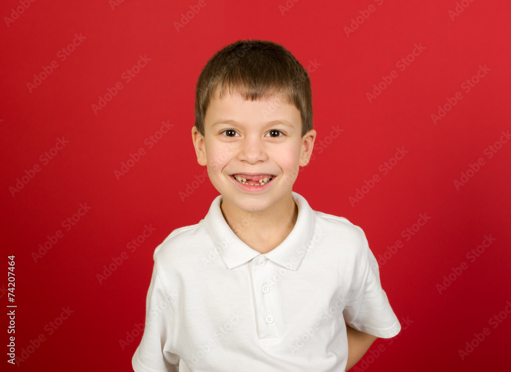 grimacing boy portrait on red grimacing boy portrait on red