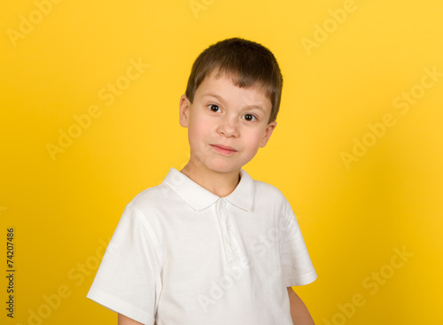 grimacing boy portrait on yellow