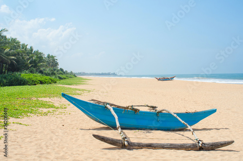 tropical beach with palms and boats in Sri-Lanka