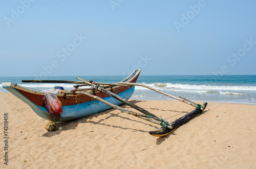tropical beach with palms and boats in Sri-Lanka