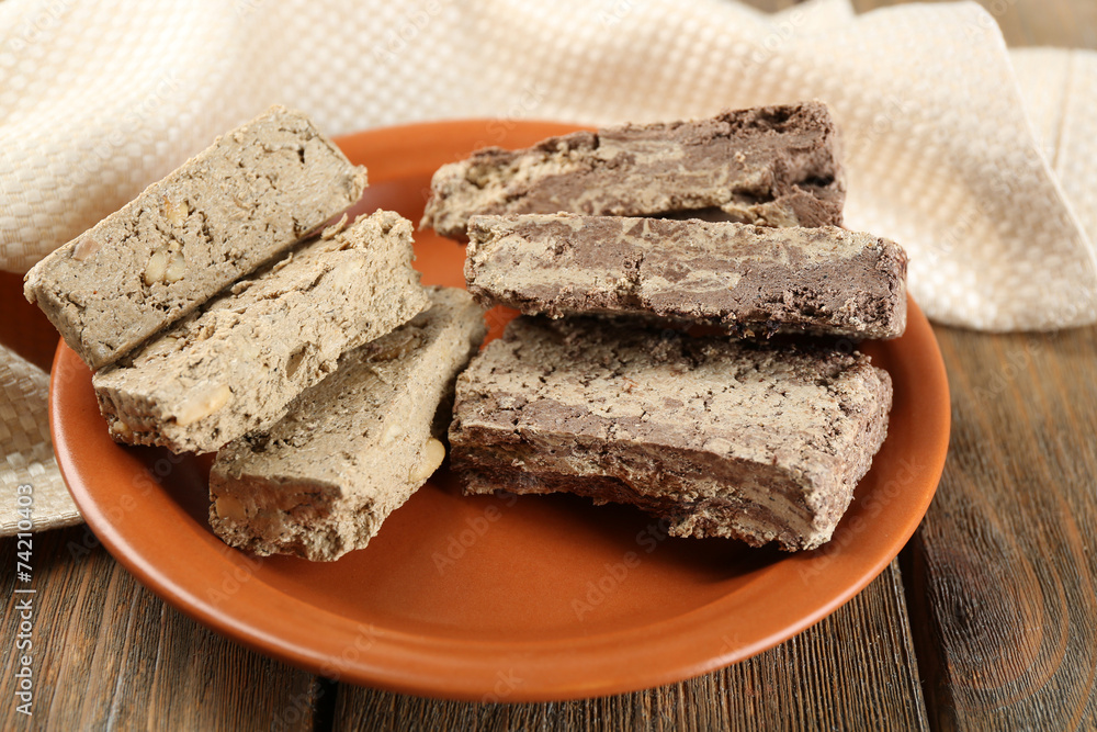 Two kinds of sunflower halva on plate, on wooden background Two kinds of sunflower halva on plate, on wooden background