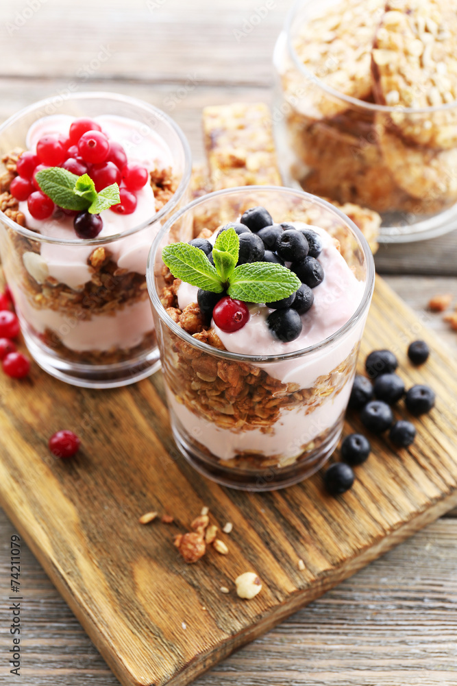 Healthy layered dessert with muesli and berries on table Healthy layered dessert with muesli and berries on table