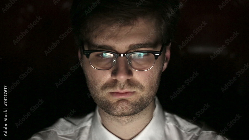 Portrait of a young man with glasses who works at night. Portrait of a young man with glasses who works at night.